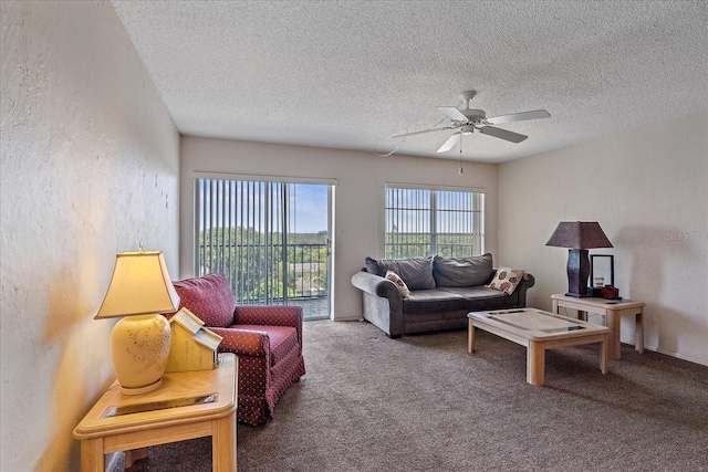 carpeted living room featuring a textured ceiling and ceiling fan