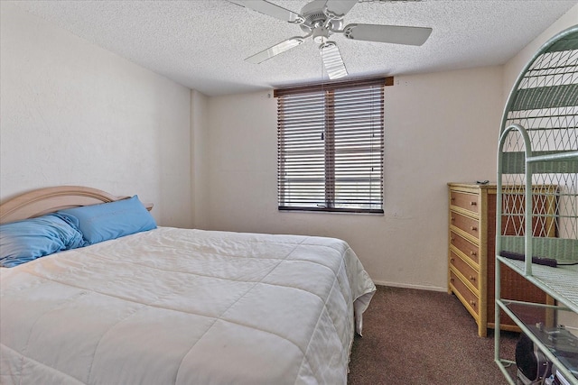 bedroom featuring dark carpet, ceiling fan, and a textured ceiling