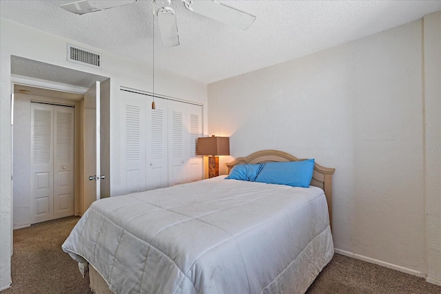 bedroom with a closet, a textured ceiling, dark carpet, and ceiling fan