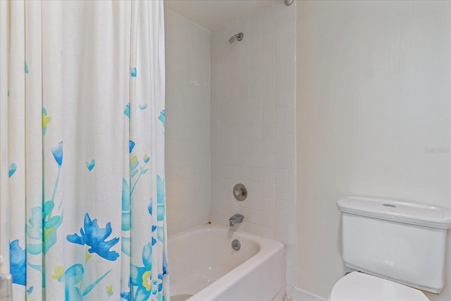 bathroom with toilet and shower / bathtub combination with curtain