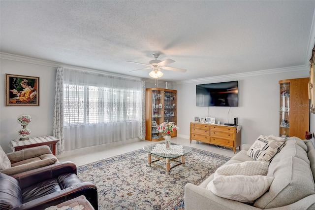 living room with a textured ceiling, a ceiling fan, and crown molding