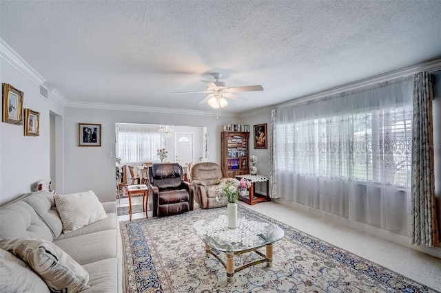 carpeted living area with ornamental molding, visible vents, a textured ceiling, and a ceiling fan