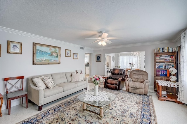 living area with crown molding, light colored carpet, visible vents, a ceiling fan, and a textured ceiling