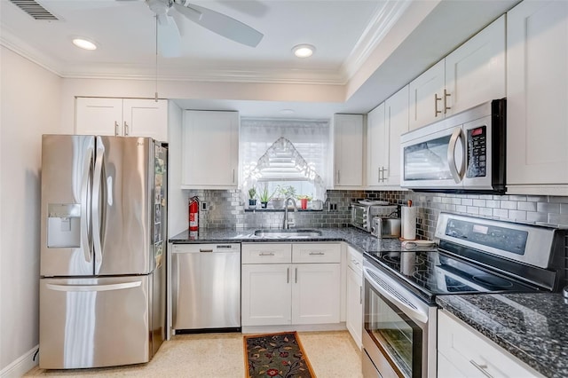 kitchen with visible vents, appliances with stainless steel finishes, dark stone counters, and a sink