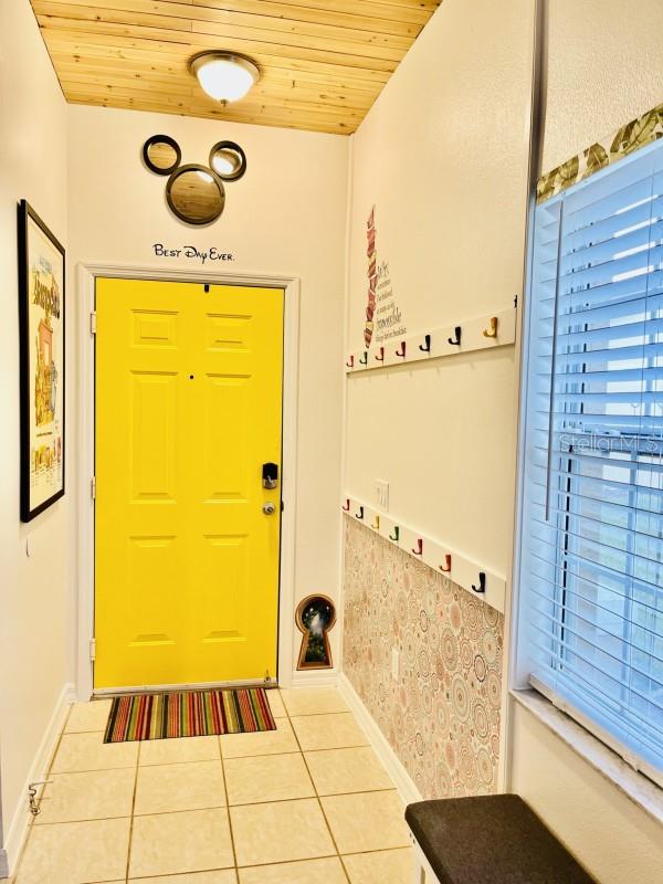 entryway featuring wooden ceiling and light tile flooring