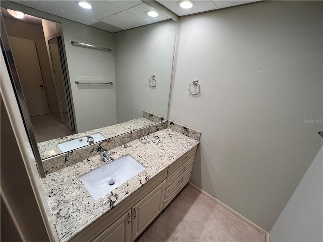 bathroom with oversized vanity and a drop ceiling