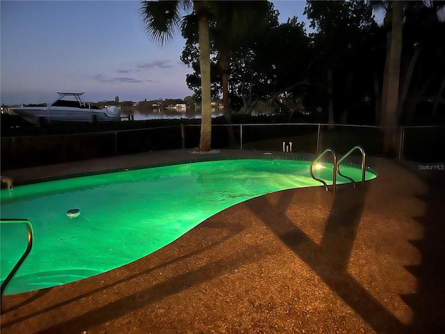 view of pool at dusk