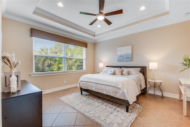 bedroom with a tray ceiling, ceiling fan, crown molding, and light tile patterned flooring