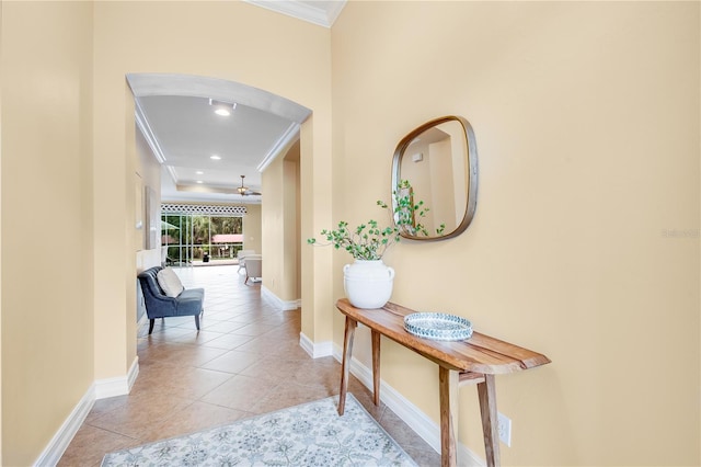 hallway featuring light tile patterned floors and crown molding