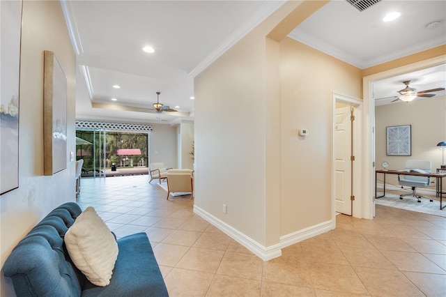 corridor featuring light tile patterned floors and crown molding