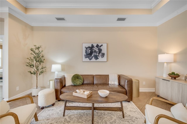 living room featuring light tile patterned floors, ornamental molding, and a tray ceiling