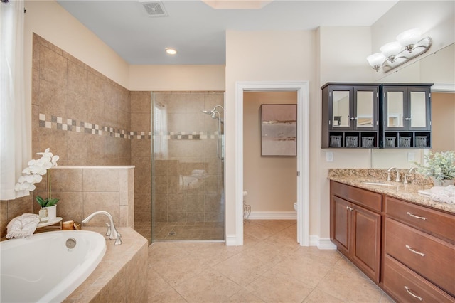 full bathroom with tile patterned flooring, vanity, toilet, and shower with separate bathtub