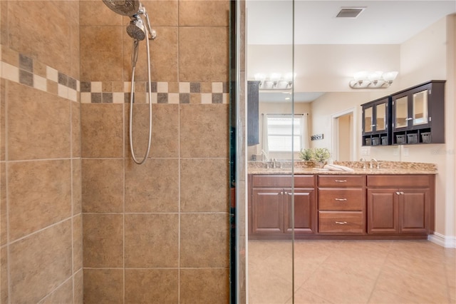 bathroom with vanity and tiled shower