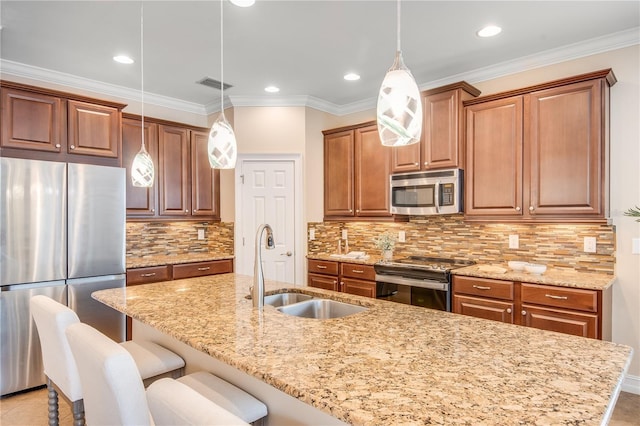 kitchen with sink, light stone counters, pendant lighting, decorative backsplash, and appliances with stainless steel finishes