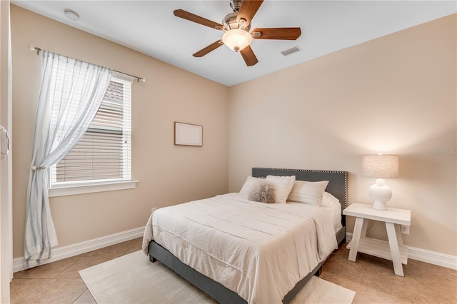 tiled bedroom featuring ceiling fan