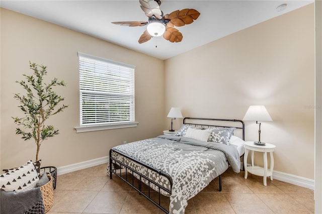 tiled bedroom featuring ceiling fan