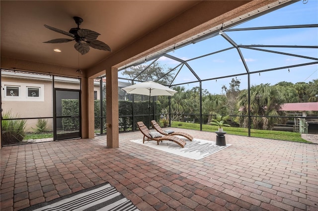 view of patio with ceiling fan and a lanai