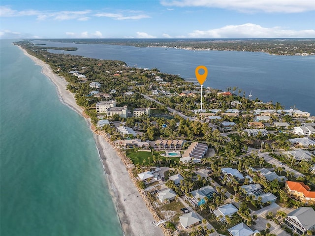 birds eye view of property featuring a beach view and a water view