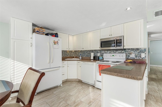 kitchen featuring white appliances, white cabinetry, backsplash, and light tile floors