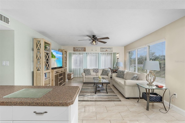 tiled living room with ceiling fan