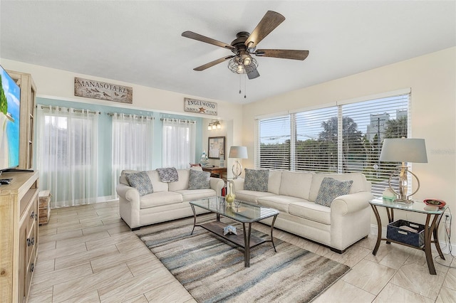 living room featuring ceiling fan and light tile floors