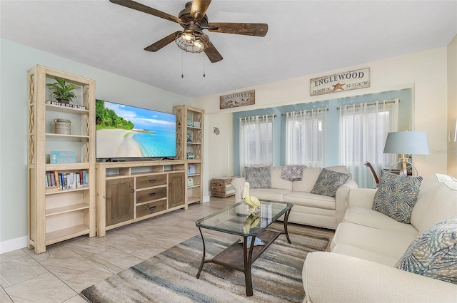 living room featuring ceiling fan and light tile flooring