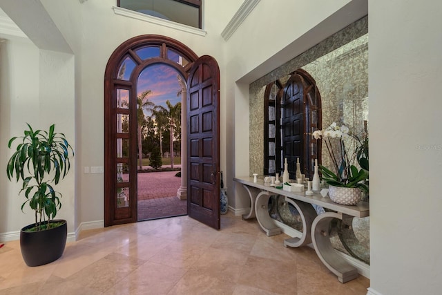 foyer entrance featuring a towering ceiling