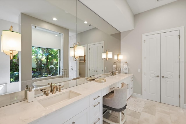 bathroom featuring vanity and a tub to relax in