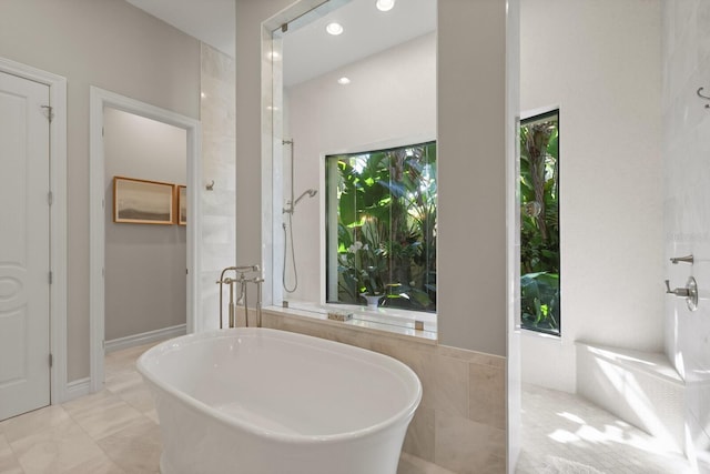 bathroom featuring shower with separate bathtub