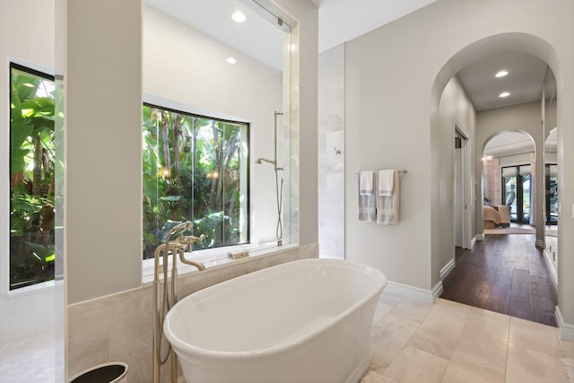 bathroom featuring tile patterned floors and a washtub