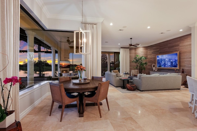 dining space with ornamental molding and ceiling fan with notable chandelier