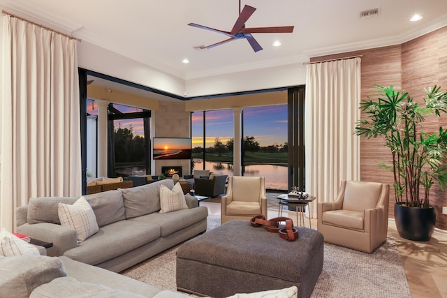 living room featuring ornamental molding and ceiling fan