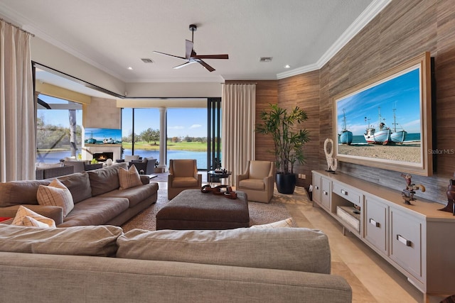 living room with ornamental molding and ceiling fan