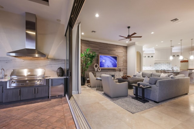 living room featuring ornamental molding and ceiling fan