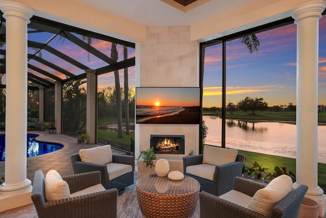 interior space featuring exterior fireplace and a water view