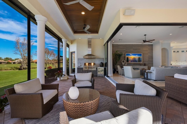 patio terrace at dusk featuring ceiling fan, area for grilling, a grill, and outdoor lounge area