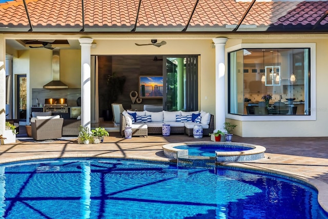 view of swimming pool with outdoor lounge area, a patio, an in ground hot tub, area for grilling, and an outdoor kitchen