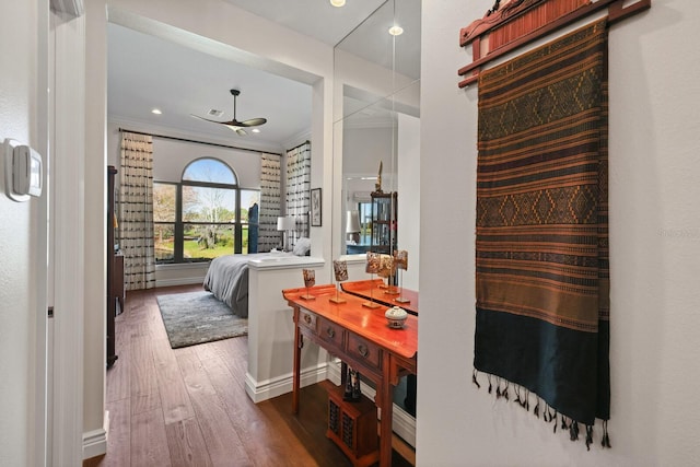 bedroom with hardwood / wood-style floors and ornamental molding