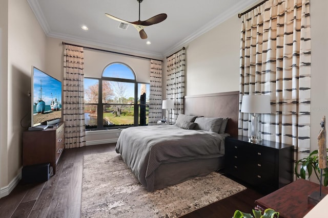 bedroom featuring crown molding, dark hardwood / wood-style floors, and ceiling fan