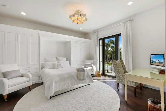 bedroom with an inviting chandelier, access to exterior, and dark wood-type flooring