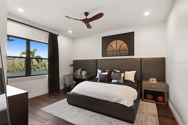 bedroom with ceiling fan and dark hardwood / wood-style floors