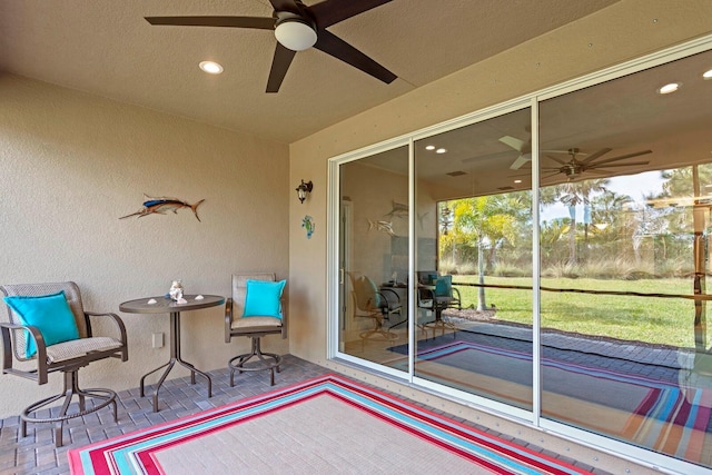 exterior space featuring ceiling fan