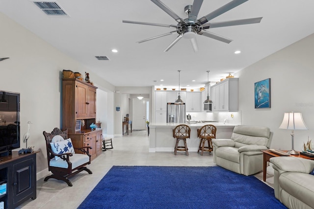 tiled living room featuring ceiling fan