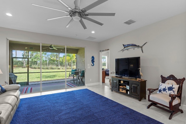 living room featuring ceiling fan and a healthy amount of sunlight