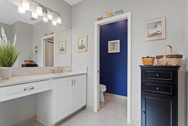 bathroom featuring vanity, toilet, and tile patterned floors