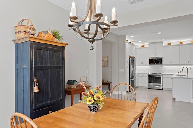 dining area with sink and a chandelier