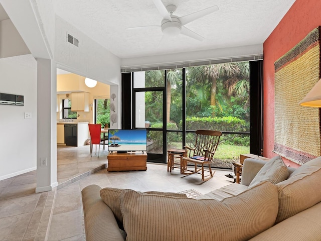 interior space featuring ceiling fan and a textured ceiling