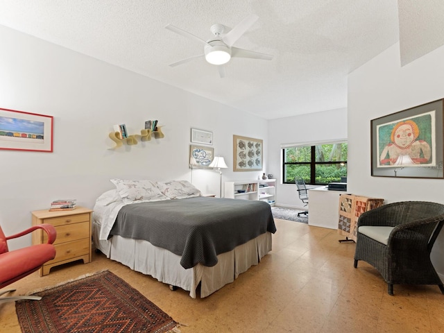 tiled bedroom with a textured ceiling and ceiling fan