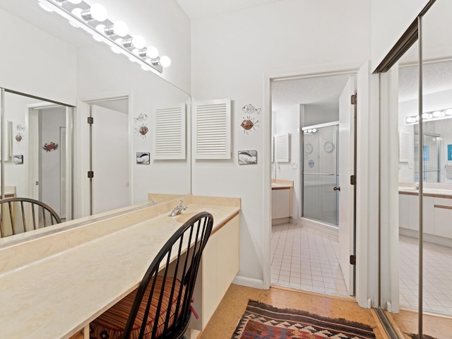 bathroom with tile floors and a shower with shower door