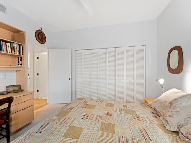 bedroom with light carpet and a closet